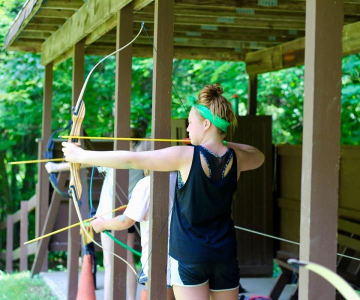 girl shooting bow and arrow